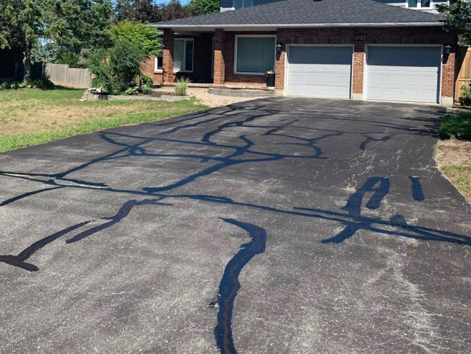 asphalt cracks repaired on a driveway