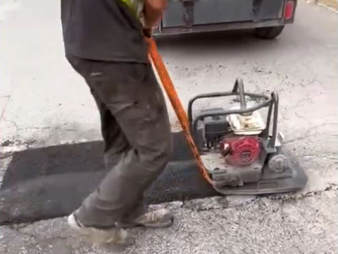 pothole filled with asphalt and compacted