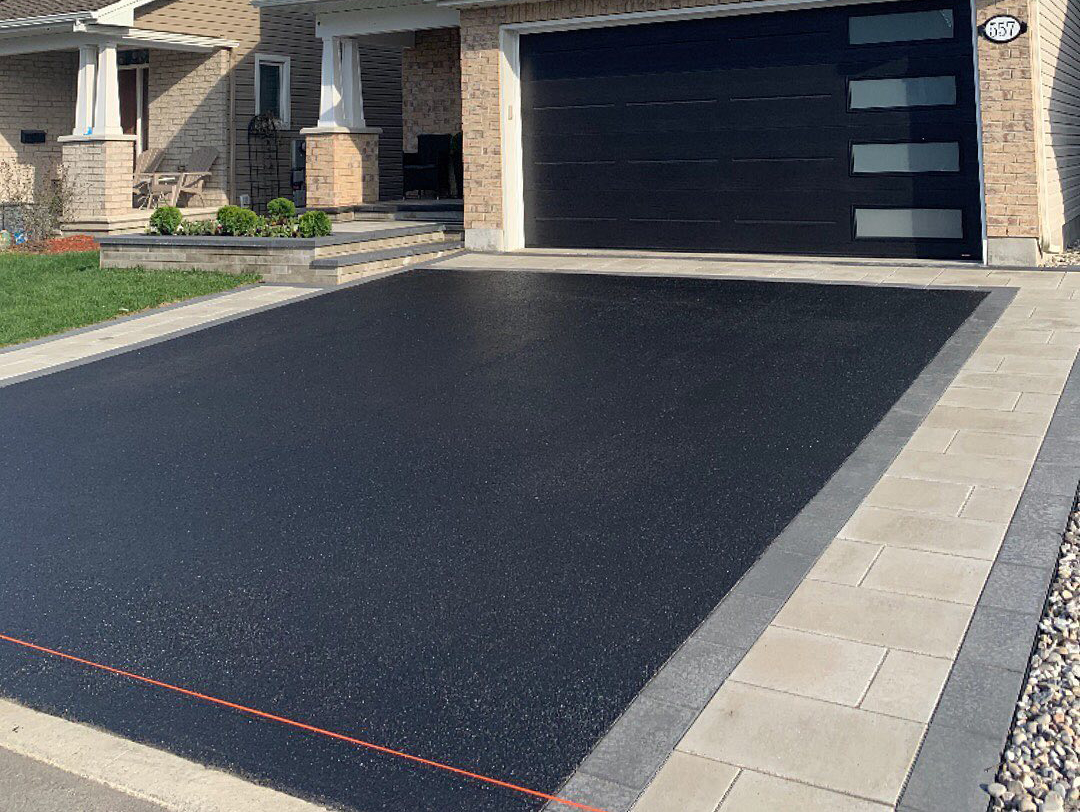 regular sized residential asphalt driveway recently sealed